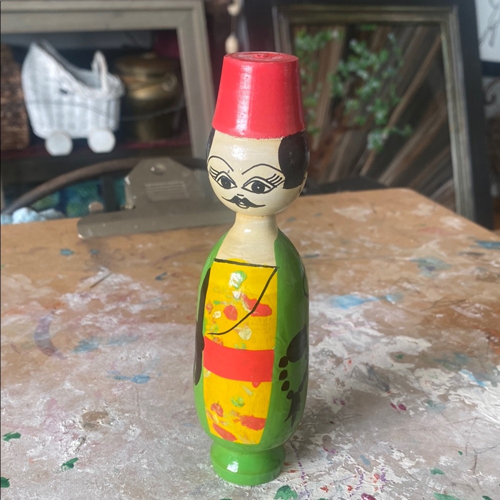 Handcrafted Wooden Doll with Red and Green Accents